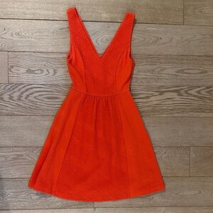 Adorable Maeve Vivid Orange Mini Dress with peekboo in back and pockets.